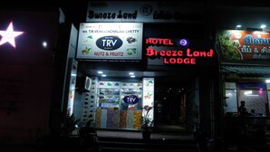 Un hôtel appelé « Breeze Land Lodge » avec une enseigne publicitaire pour TRV, ainsi qu’une variété de collations et de fruits.