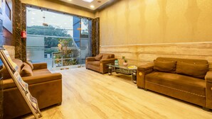 A modern living room with two sofas, a glass coffee table, and a fireplace.
