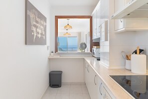 Fridge, microwave, coffee/tea maker, cookware/dishes/utensils