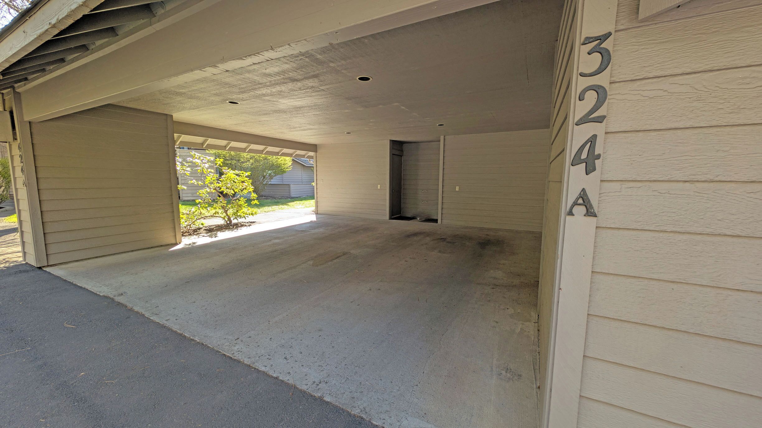 A garage with a concrete floor and a closed garage door.