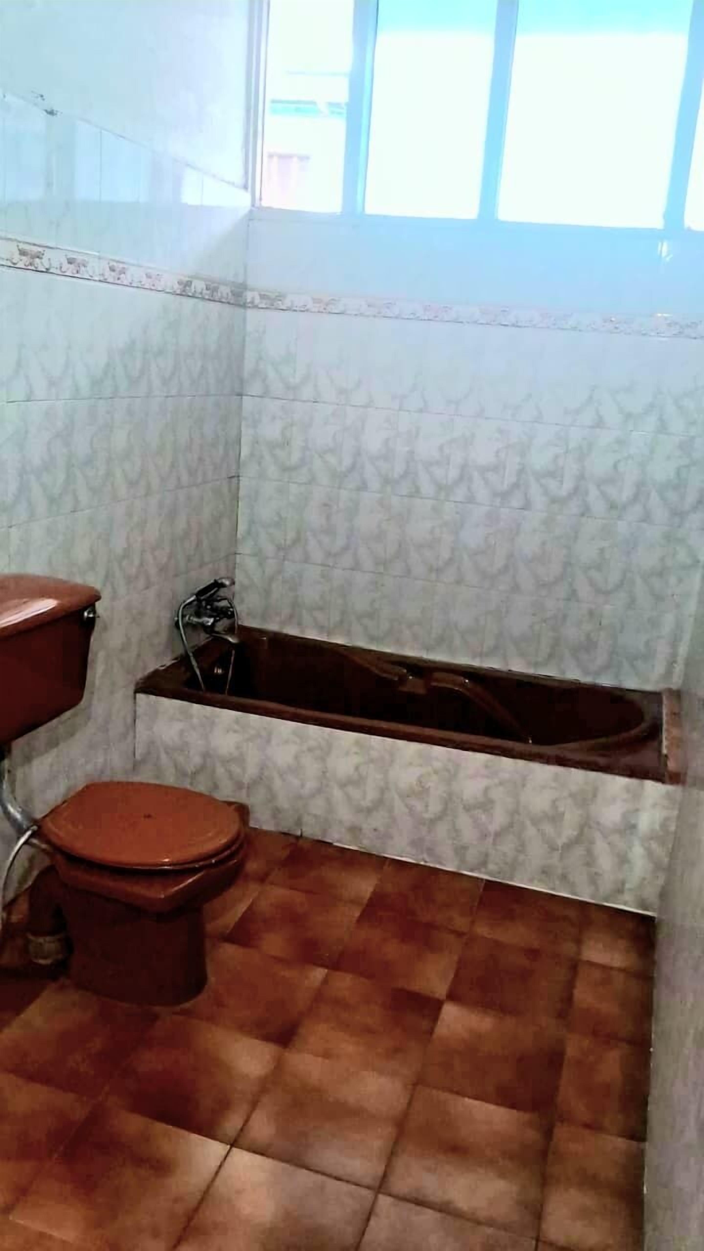 A bathroom with a toilet, a sink, and a bathtub.