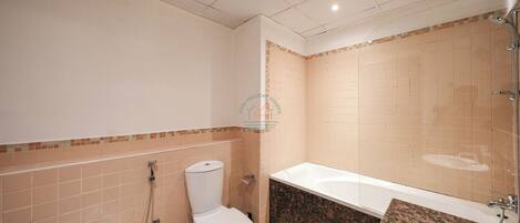 A bathroom with a toilet, sink, and bathtub.