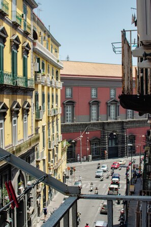 A street view with buildings, vehicles, and a pedestrian. - MAESTOSA CASA IN NAPOLI CENTRO (Naples)