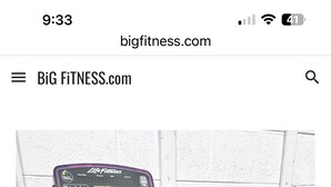 A Life Fitness Integrity CLSG upright bike with a control panel, handlebars, and a seat.