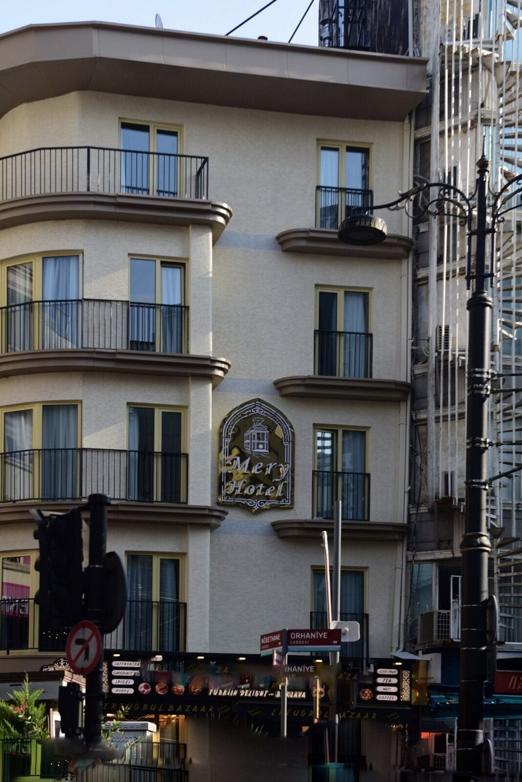 A multi-story hotel with a distinct arched sign reading 'Merry Hotel' above the entrance.