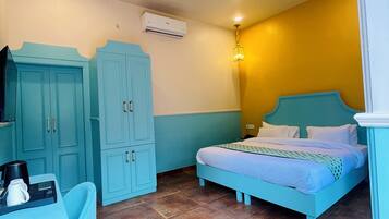 Ein Zimmer mit einem Bett, einem Schreibtisch und einem Stuhl. An der Wand befindet sich eine Klimaanlage und ein Deckenventilator.