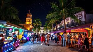 A bustling street scene with people walking and dining outdoors. - Terrace Oasis w/ Private Jacuzzi and Stunning View (Puerto Plata)