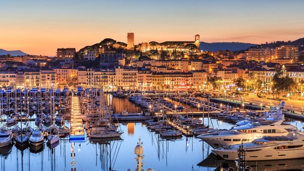 A marina filled with boats, a historic tower, and buildings along the waterfront. - Le Suquet - 2 bedroom - terrace (Cannes)