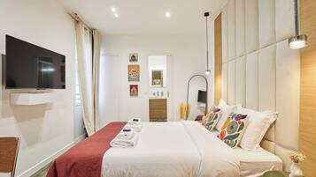 Apartment | Laptop workspace, iron/ironing board, bed sheets