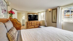 A bedroom with a large bed, wooden dresser, and a television. - Quaint Coos Bay Escape, 2 Mi to Downtown (Coos Bay)