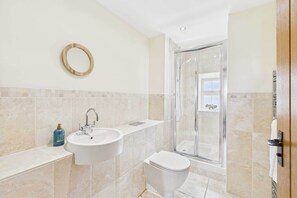 Shower, hair dryer, towels, shampoo
