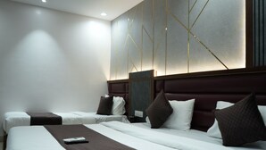 A hotel room with two beds, a large wall art piece, and a modern design. - The samsara Hotel by Satyug (Ujjain)