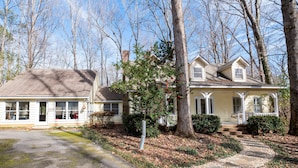 A two-story house with a porch and a driveway leading to the front door. - 371 Mountain Hill Rd, Fortson (Harris County)