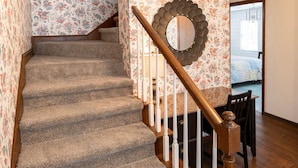 A carpeted staircase with wooden railings and a decorative mirror on the wall. - 371 Mountain Hill Rd, Fortson (Harris County)