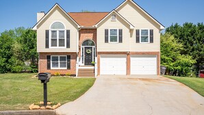 A two-story house with a front garage, a brick entrance, and a well-maintained lawn. - 18 Huntcliff Dr, Cartersville (Cartersville)