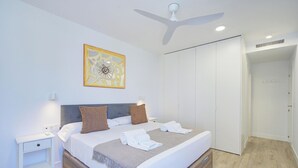 A modern hotel room with a large bed, a ceiling fan, a nightstand, and a wardrobe. - Ref. 585392 (Motril)