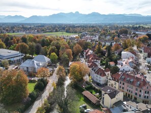 An aerial view of a town with buildings, roads, and a river.