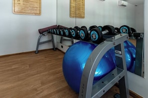 A gym with a row of dumbbells, a blue exercise ball, and a wooden floor. - Suite Lumaire 1br | Pool view | the title v rawai (Rawai)