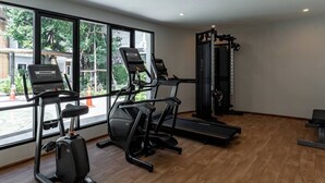 A gym with treadmills, a stationary bike, and a weight machine.