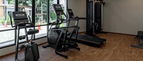 A gym with treadmills, a stationary bike, and a weight machine.