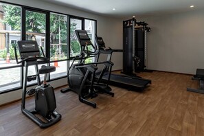 A gym with treadmills, a stationary bike, and a weight machine. - Suite Lumaire 1br | Pool view | the title v rawai (Rawai)