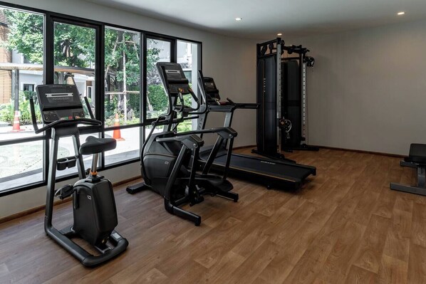 A gym with treadmills, a stationary bike, and a weight machine.