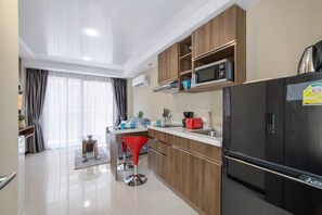 Fridge, microwave, stovetop, dining tables