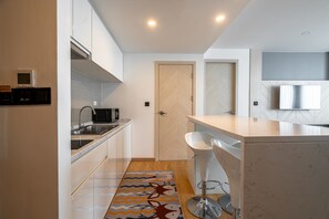 Fridge, microwave, stovetop, dining tables