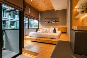 A modern bedroom with a bed, a cityscape view, and a wooden ceiling.