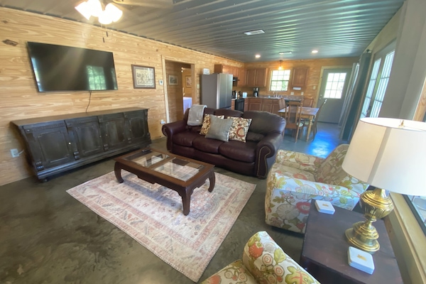 Den- Leather couch, ceiling fan, smart t.v., two swivel rocking chairs