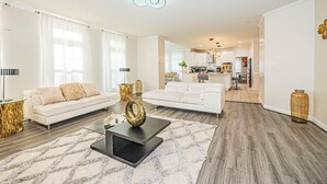 A modern living room with a sectional sofa, a coffee table, and a rug.