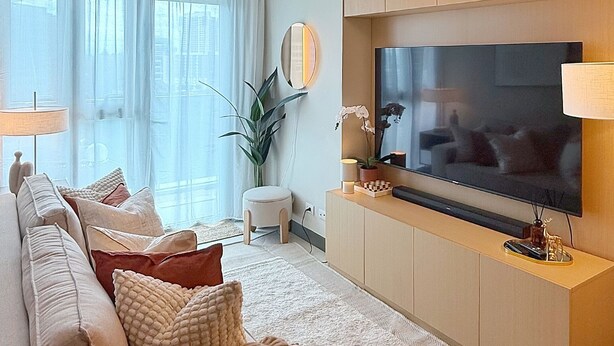 Un salon moderne avec un canapé, un téléviseur et des objets de décoration.