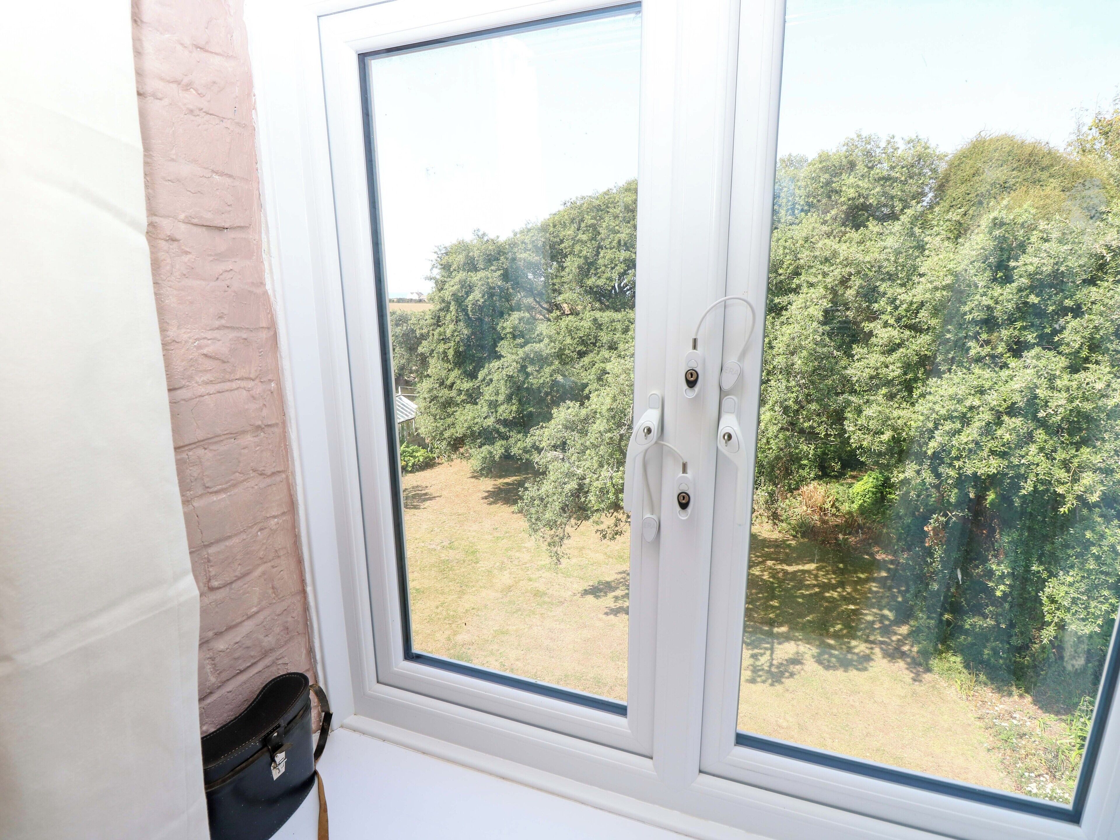 A window with a view of a green landscape.