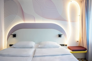 Hypo-allergenic bedding, desk, laptop workspace, blackout drapes