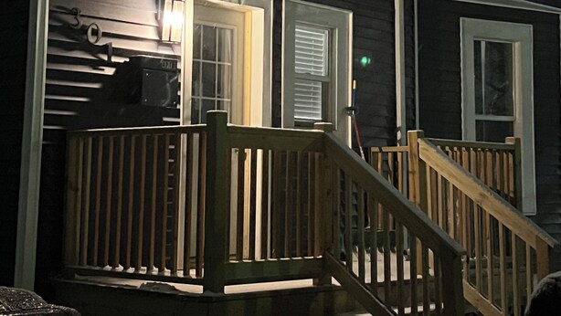 A house with a wooden deck and a staircase leading to the front door. - Delightful apt with AC near historic Midland St district, office, tiled shower (Bay City)