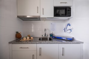 Mini-fridge, microwave, stovetop, cookware/dishes/utensils