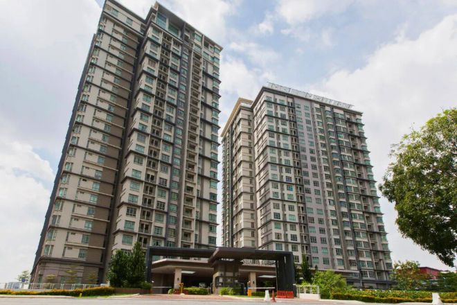 A high-rise residential building with multiple floors, a covered entrance, and a landscaped area in front.