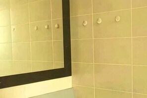 A tiled wall with a black border and several round wall-mounted objects. - The Edge Suites - Cyber Prime Stay (Cyberjaya)
