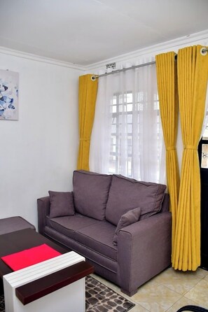 Deluxe Apartment | Living area | 32-inch Smart TV with digital channels