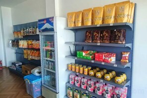 A snack and beverage vending area with various packaged goods and drinks.