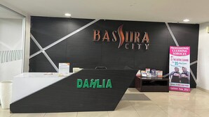 A reception desk with the name "Dahlia" and a sign for "Bassura City Professional Cleaning Services". - Apartment Bassura City By Berkah Estate By Zuzu (Jakarta)