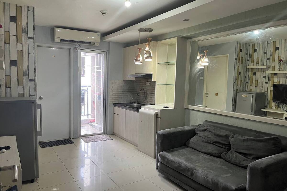 A modern kitchen with a built-in oven, a sink, and pendant lighting.