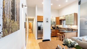 A modern kitchen with stainless steel appliances, wooden cabinets, and a central island. - Mountain Retreat in East Vail, 2BR/2BA Condo w/ Pool & Hot Tub (Vail)