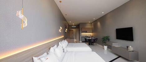 Una habitación de hotel moderna con una cama grande, un escritorio, un televisor de pantalla plana y una pequeña cocina.