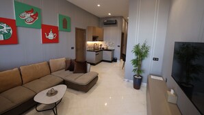 A modern living room with a sofa, coffee table, and artwork on the wall. - La villa luxury suites (Marrakech)