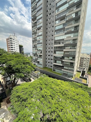 A high-rise building with multiple floors, large windows, and balconies.