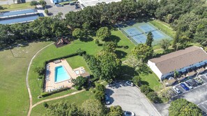 An aerial view of a property with a swimming pool, tennis courts, and a parking lot. - The Capri Villa Stay for 6 (Tampa)