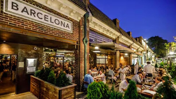 A bustling outdoor dining area with a brick facade and a sign that reads "BARCELONA." - Private Rooftop, Near Vanderbilt, only 2 Miles from Downtown (Nashville)
