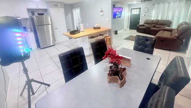 A modern living space with a kitchen, dining area, and seating area.