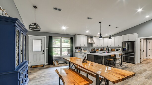 A modern kitchen with a wooden island, white cabinets, and stainless steel appliances. - Private Beach on Lake Barkley! Scenic Family Oasis (Cadiz)